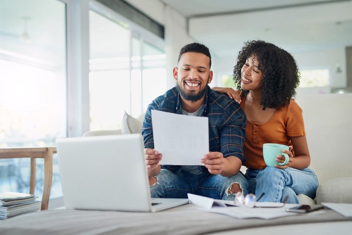 A couple reviewing wealth accumulation strategies and examples.