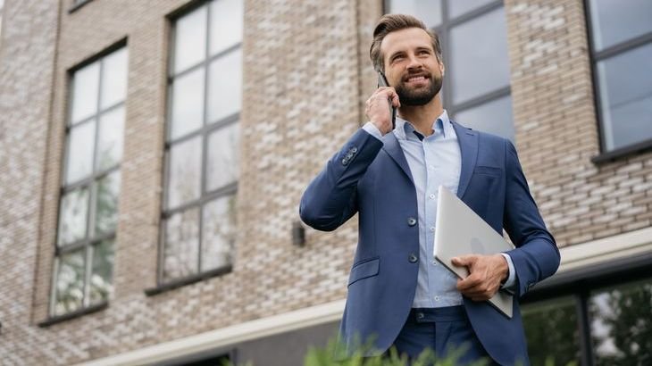 A real estate investor makes a call after touring a commercial property that