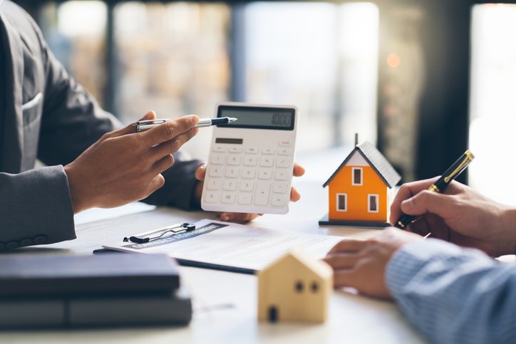 Real estate investors discussing how to calculate the cap rate for different investment properties.