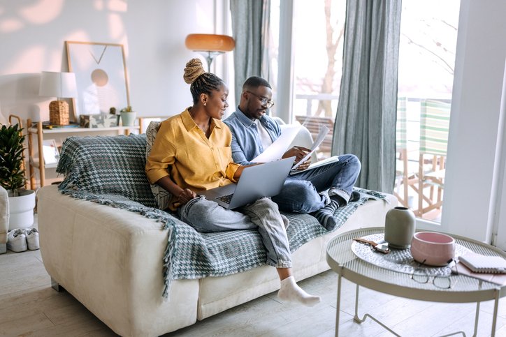 A young couple reviewing modern wealth creation methods.